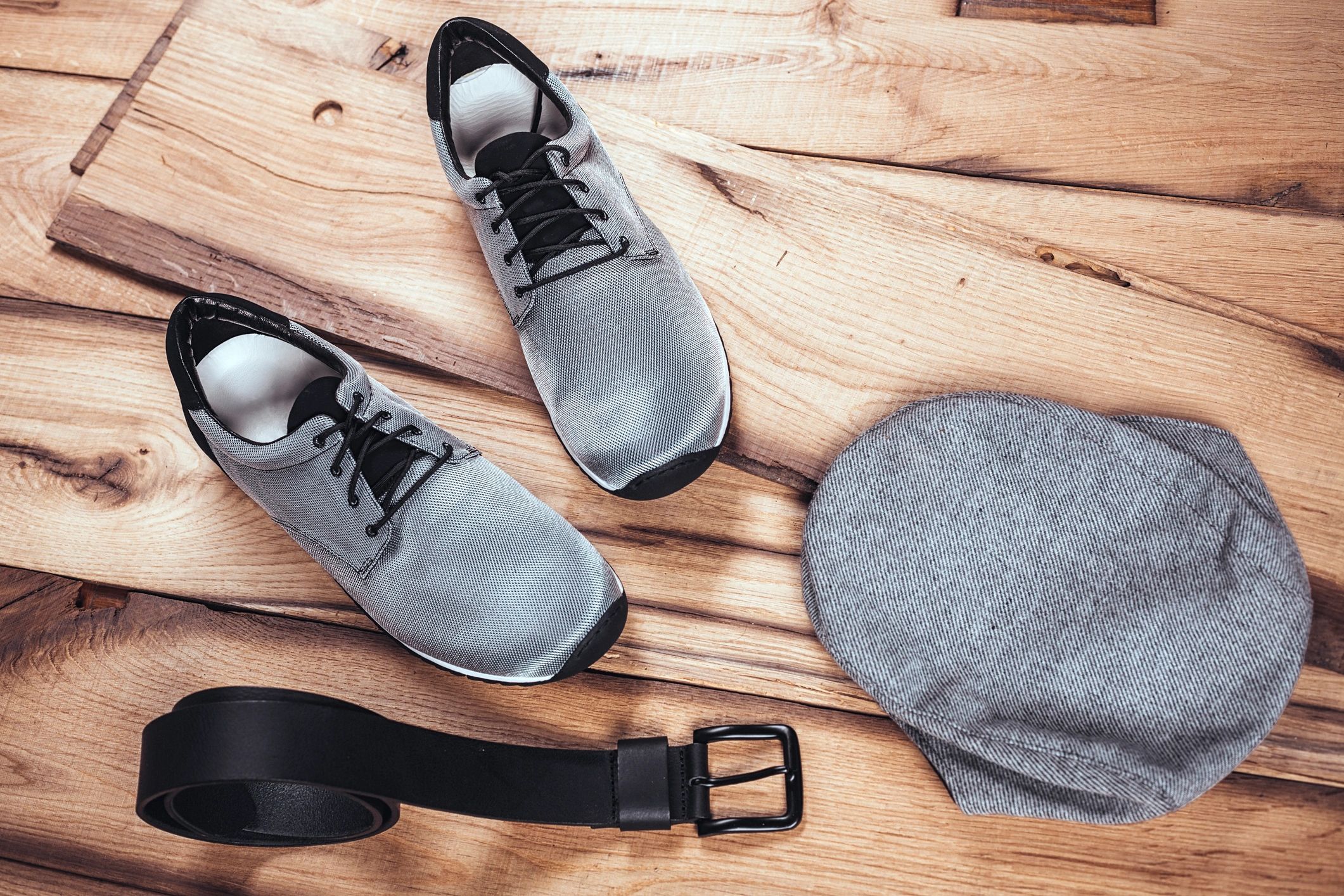 Minimal flat lay of men's accessories including shoes